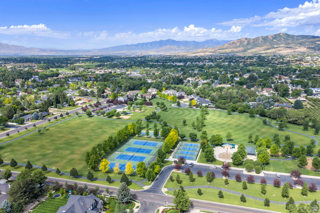 650 East Center Street Alpine, UT 84004 - Photo 5 of 38 Expansive green spaces featuring Creekside Park with manicured lawns, tennis & pickleball, and mature trees, all set against a backdrop of distant mountains