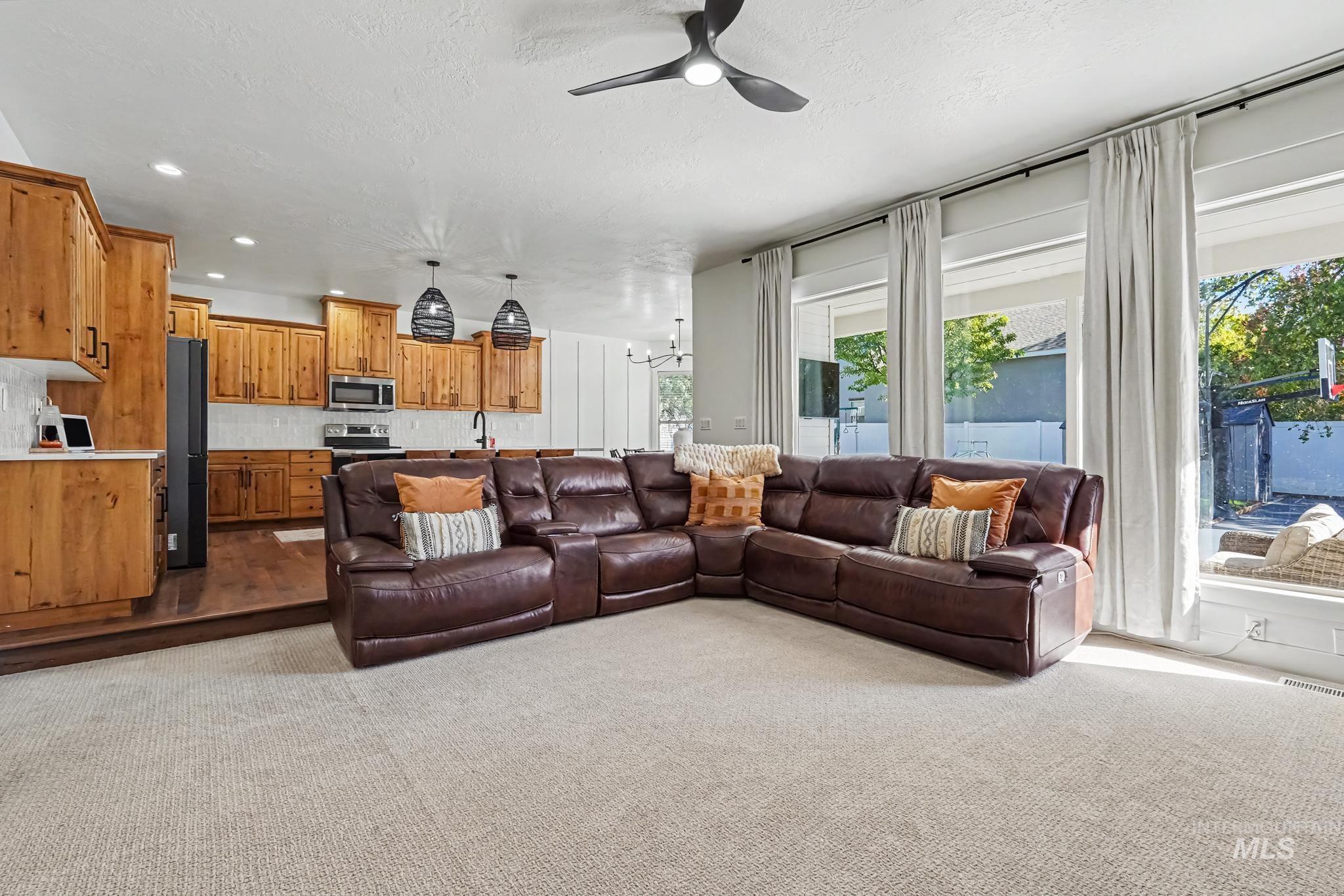 2340 South Alaska Way Meridian, ID 83642 - Photo 13 of 48 Open concept living area featuring natural wood cabinetry and a tile backsplash