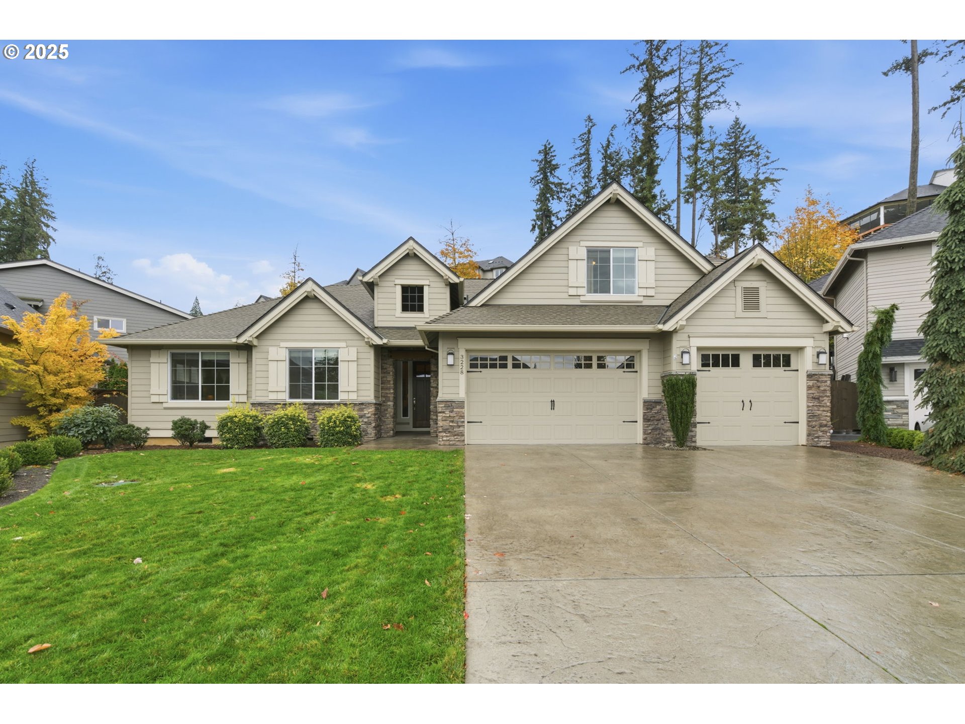 a view of a house with a big yard and large trees
