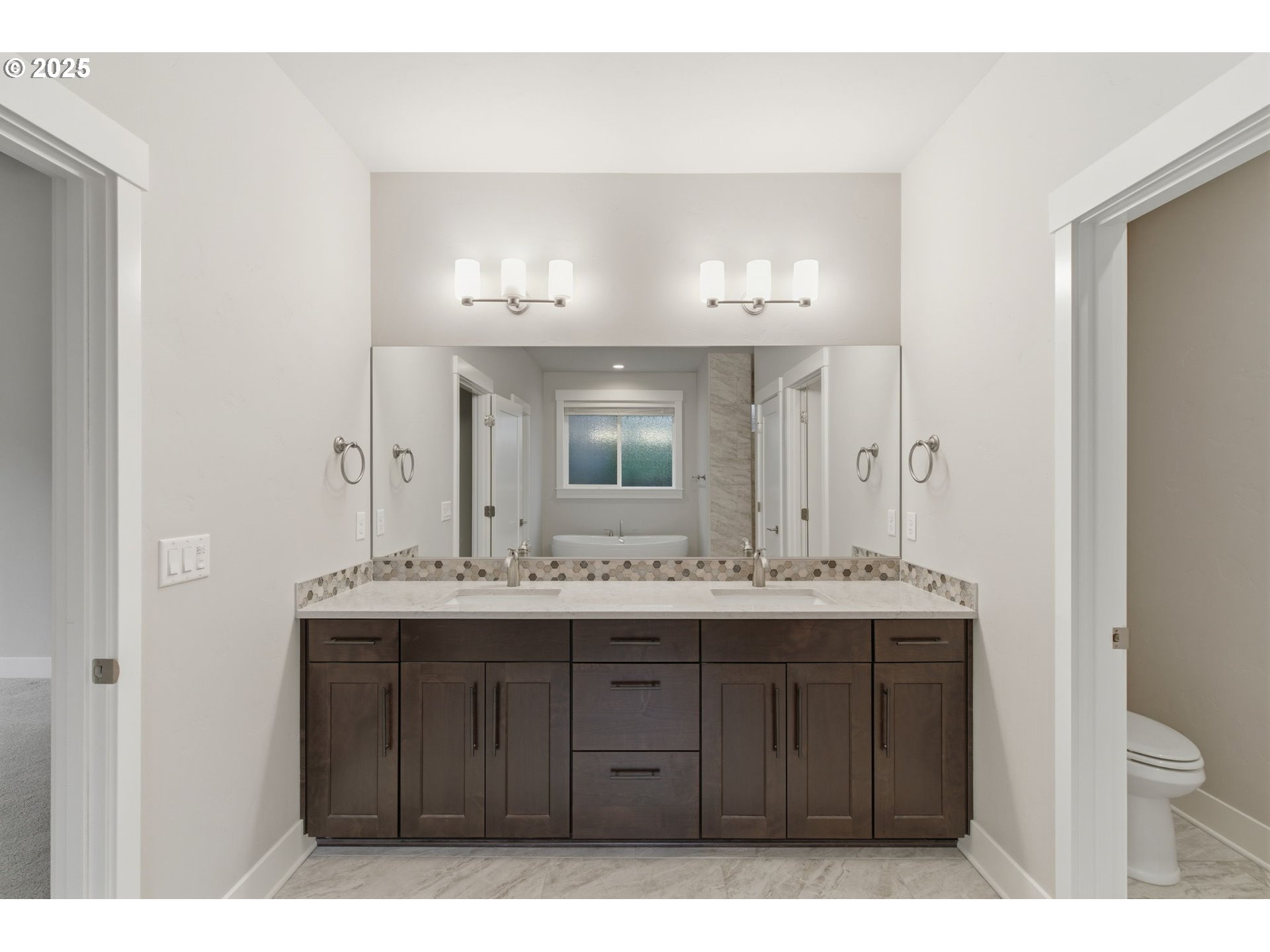3228 Northwest Hood Court Camas, WA 98607 - Photo 12 of 28 a bathroom with a granite countertop sink a toilet and a mirror