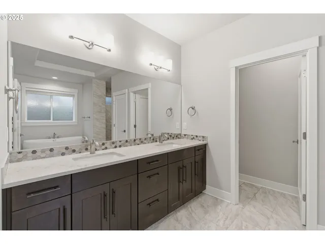 a bathroom with a double vanity sink and mirror