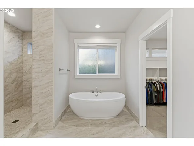 a spacious bathroom with a sink and a mirror
