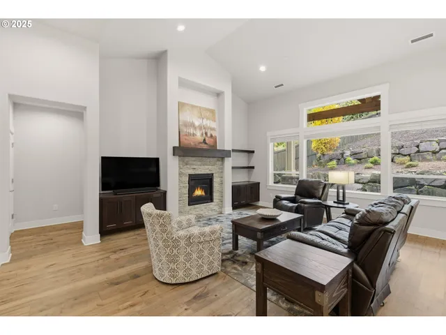 a living room with furniture a fireplace and a flat screen tv