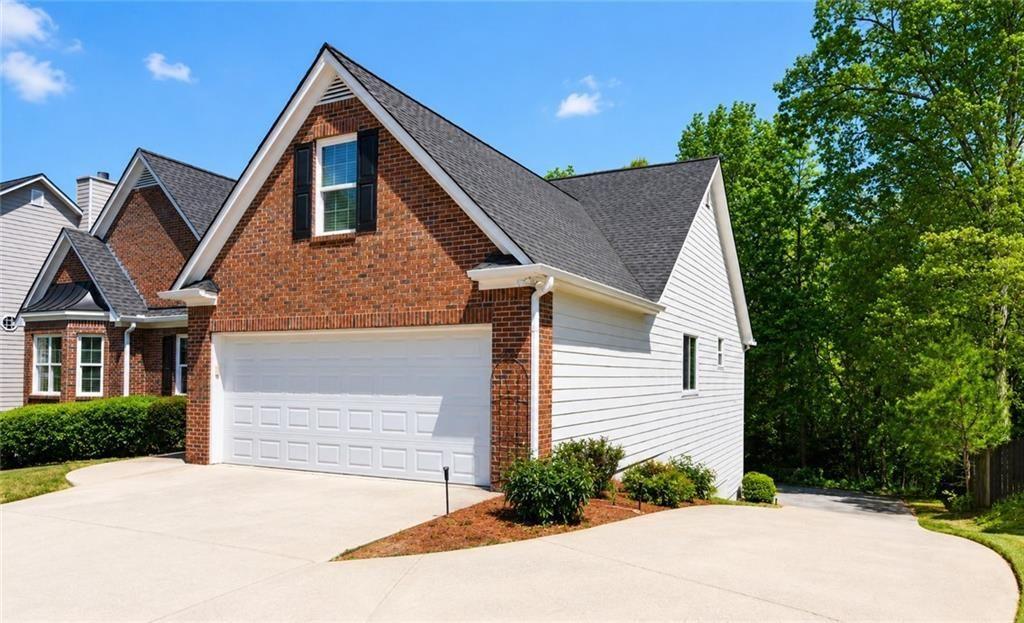795 Sunset Ridge Lane Southeast Lawrenceville, GA 30045 - Photo 6 of 47 a front view of a house with a yard and garage