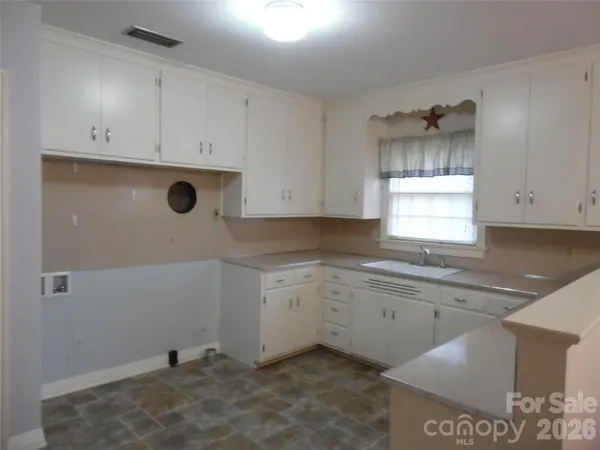 a kitchen with a sink and cabinets