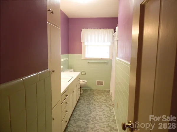a bathroom with sink a bathtub and window
