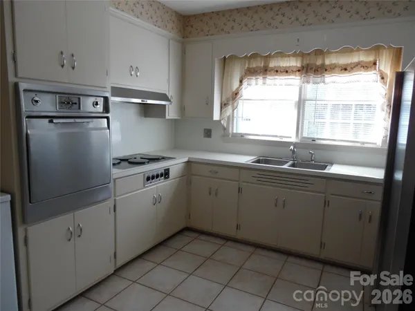 a kitchen with cabinets appliances and a window