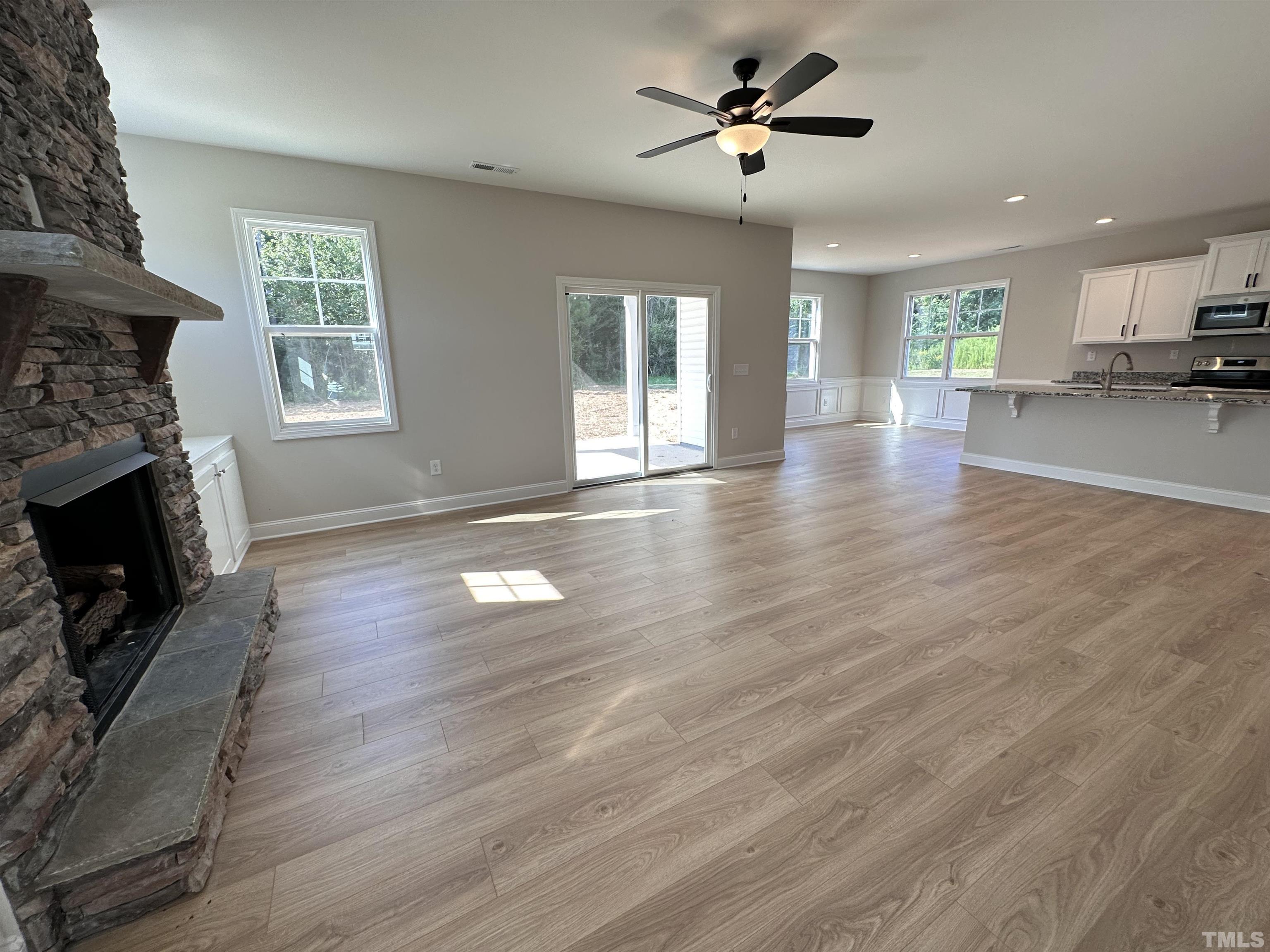 386 Jackson Pond Drive Smithfield, NC 27577 - Photo 2 of 10 a view of empty room with wooden floor and fireplace