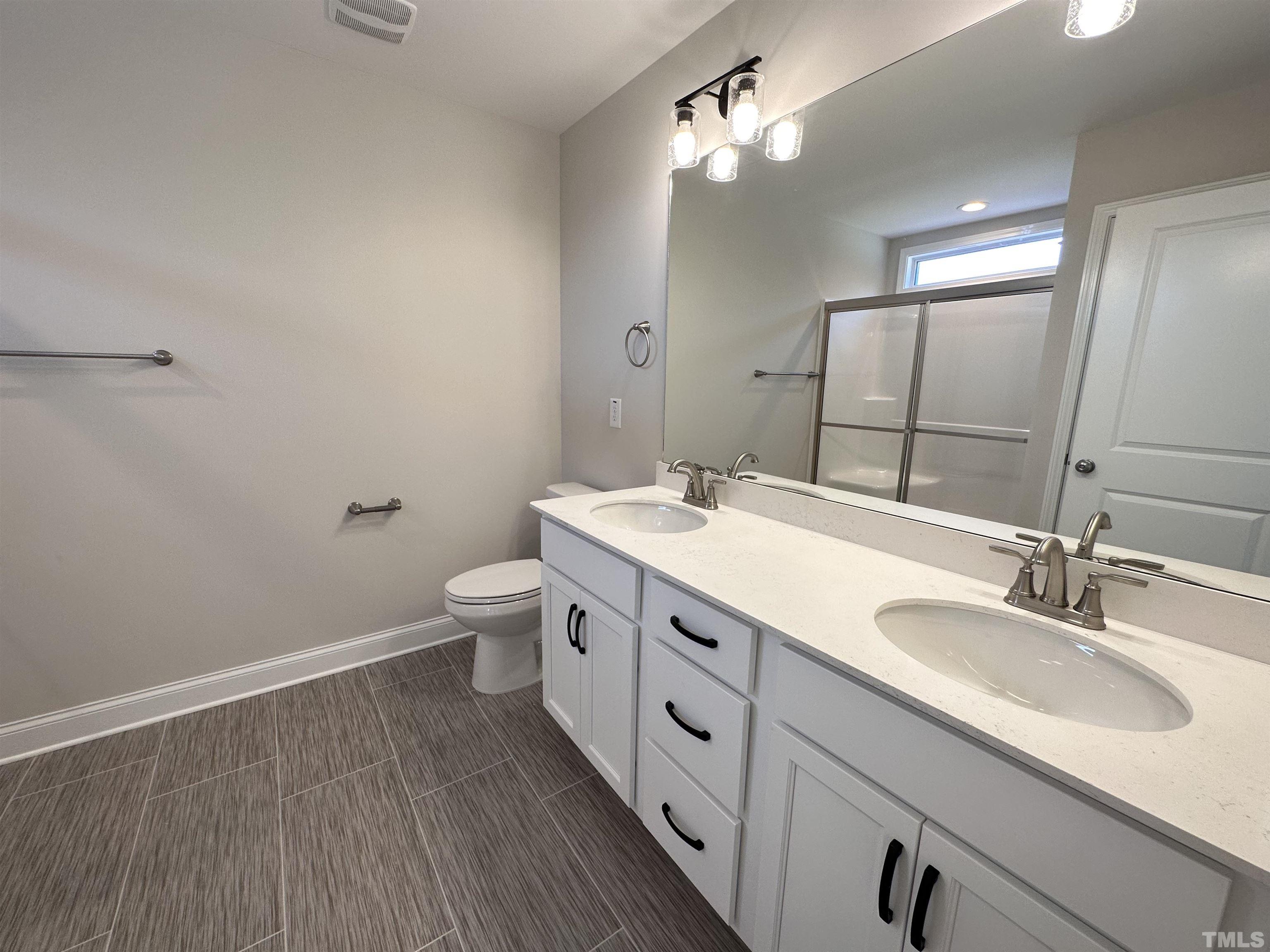 386 Jackson Pond Drive Smithfield, NC 27577 - Photo 5 of 10 a bathroom with a double vanity sink toilet and a mirror