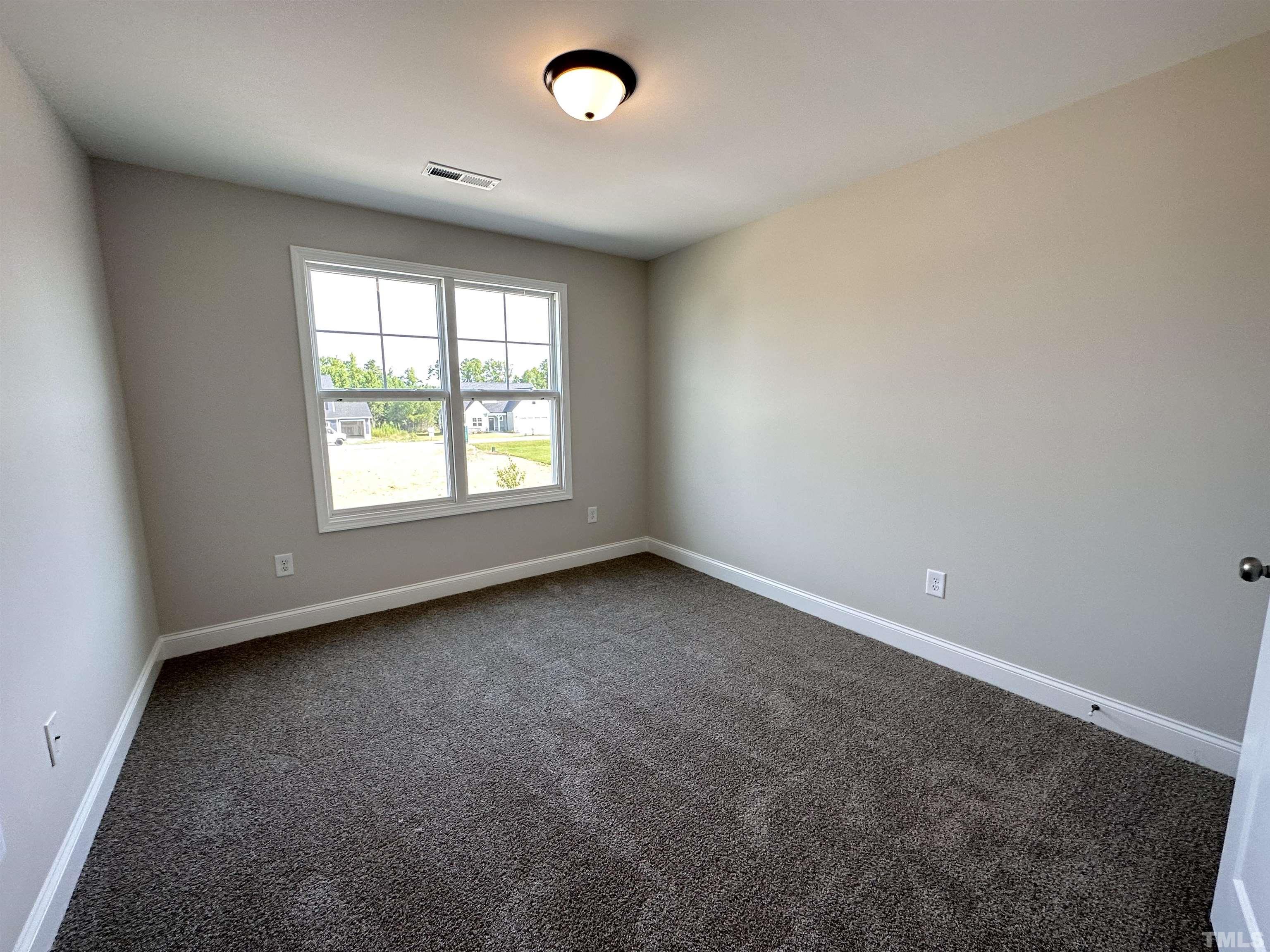 386 Jackson Pond Drive Smithfield, NC 27577 - Photo 6 of 10 an empty room with a window