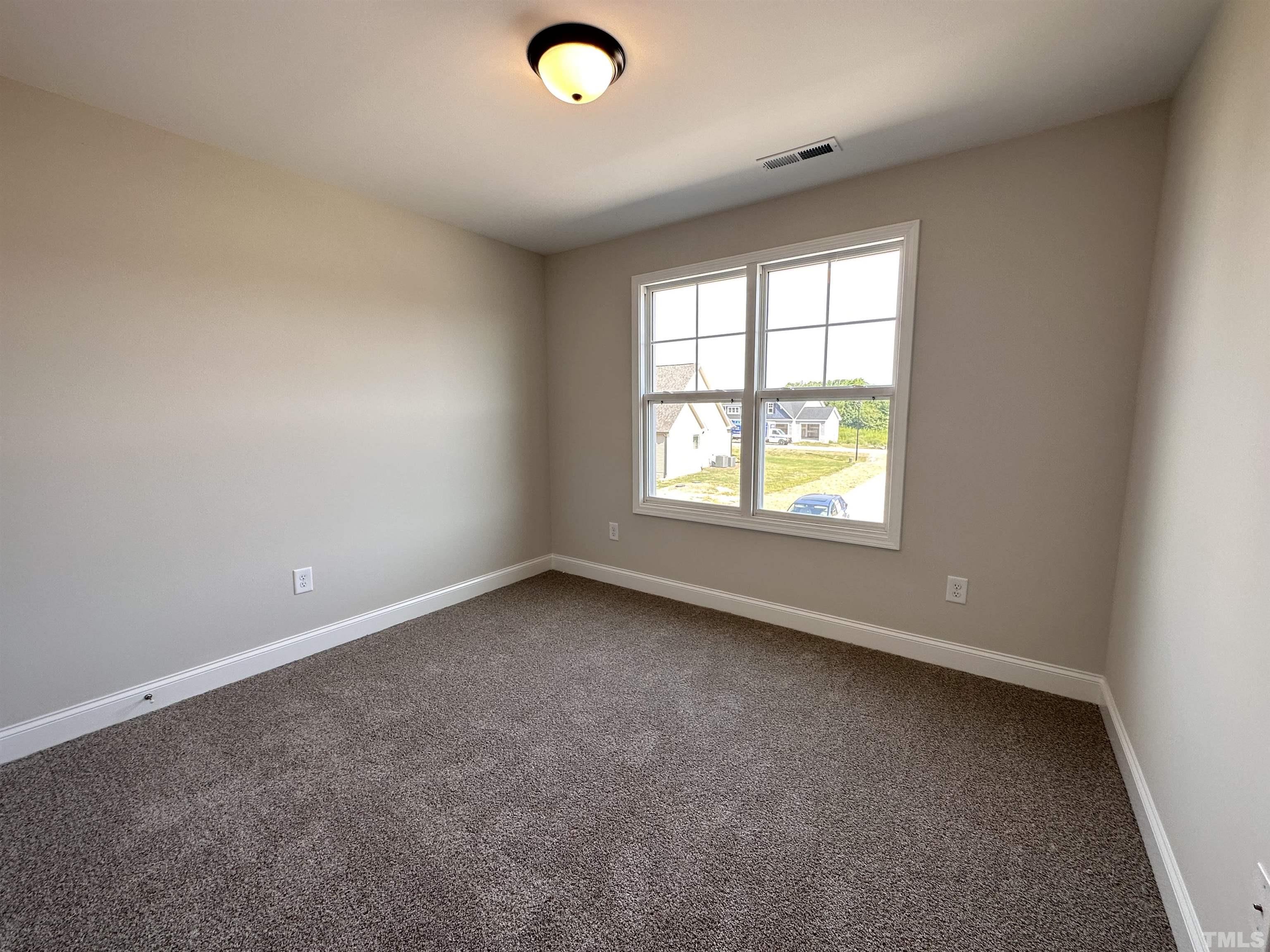 386 Jackson Pond Drive Smithfield, NC 27577 - Photo 7 of 10 an empty room with a window
