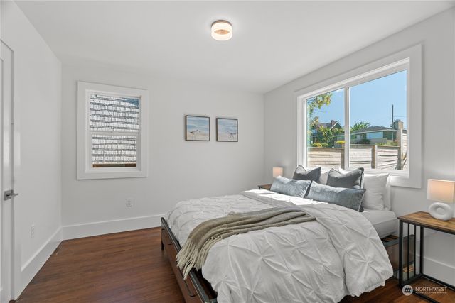a bedroom with a bed and a large window