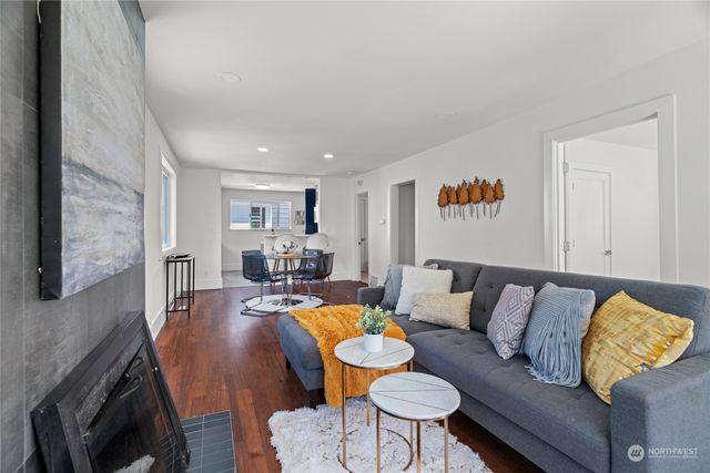 a living room with furniture and a kitchen view