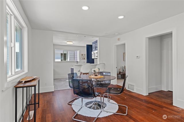 a view of a dining room with furniture and wooden floor