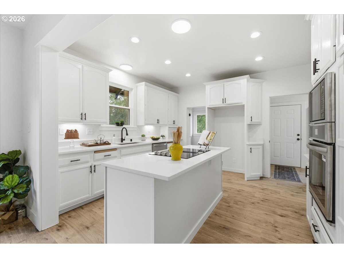 1313 Hining Road Winlock, WA 98596 - Photo 13 of 46 a kitchen with stainless steel appliances kitchen island sink stove and refrigerator