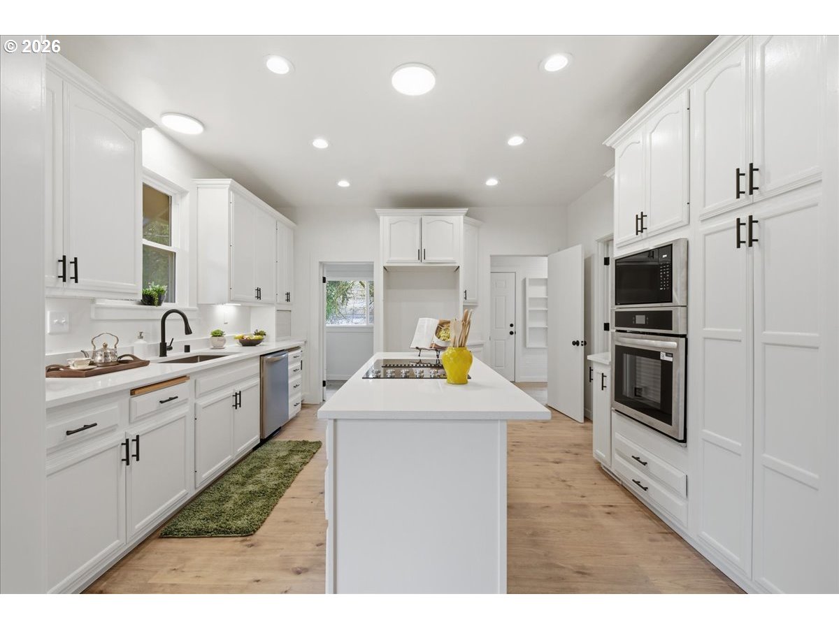1313 Hining Road Winlock, WA 98596 - Photo 14 of 46 a kitchen with a sink stainless steel appliances and white cabinets