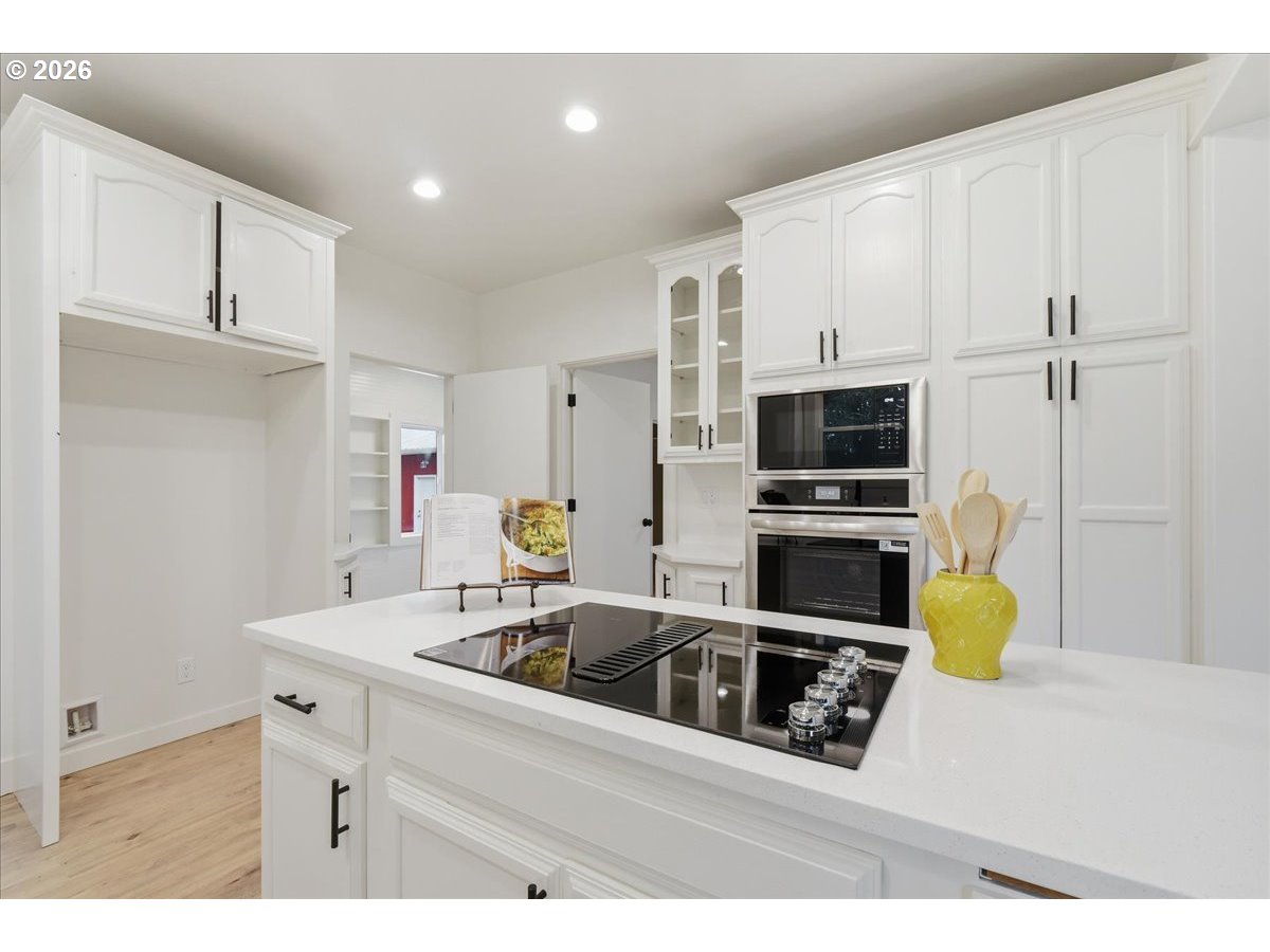 1313 Hining Road Winlock, WA 98596 - Photo 16 of 46 a kitchen with stainless steel appliances a sink a microwave a refrigerator and white cabinets