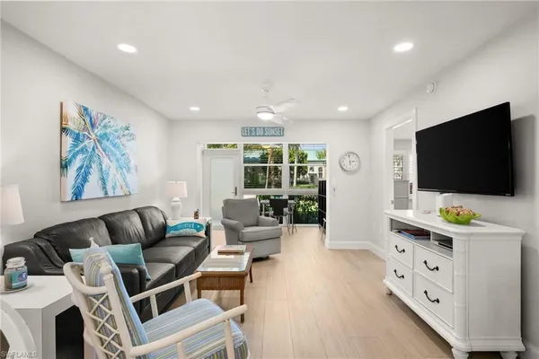 a living room with furniture a dining table and chairs