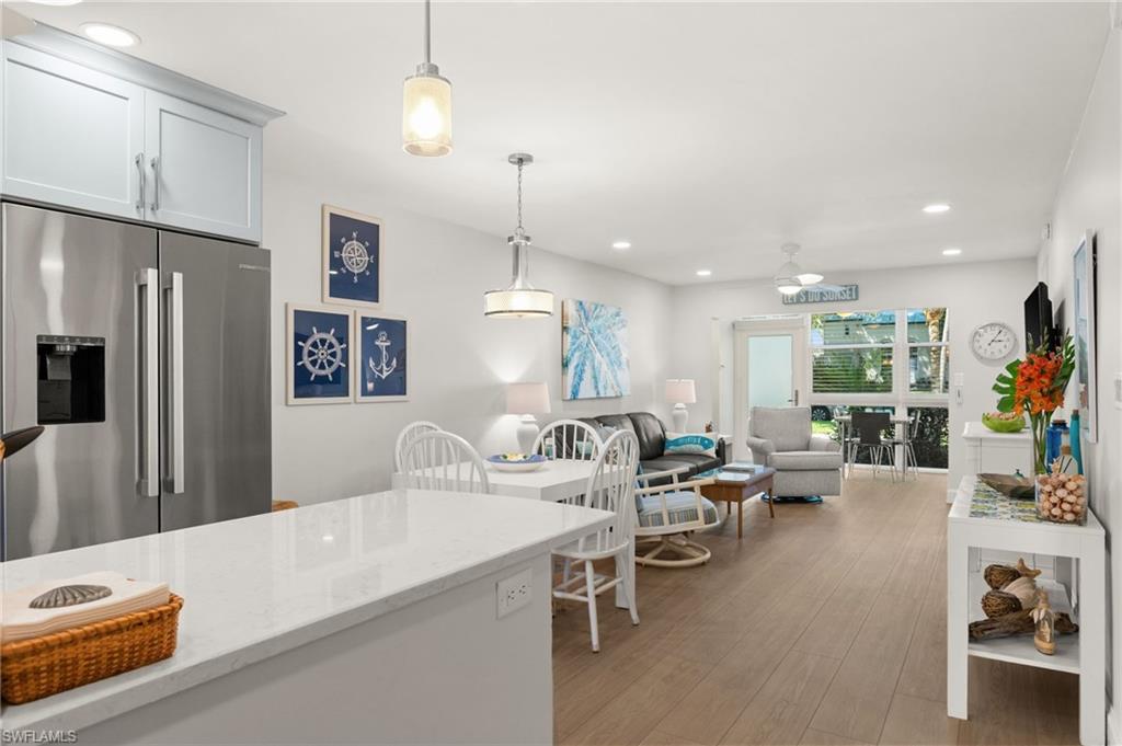 1021 3rd Street South, Unit 108 Naples, FL 34102 - Photo 13 of 31 a living room with furniture a dining table and chairs