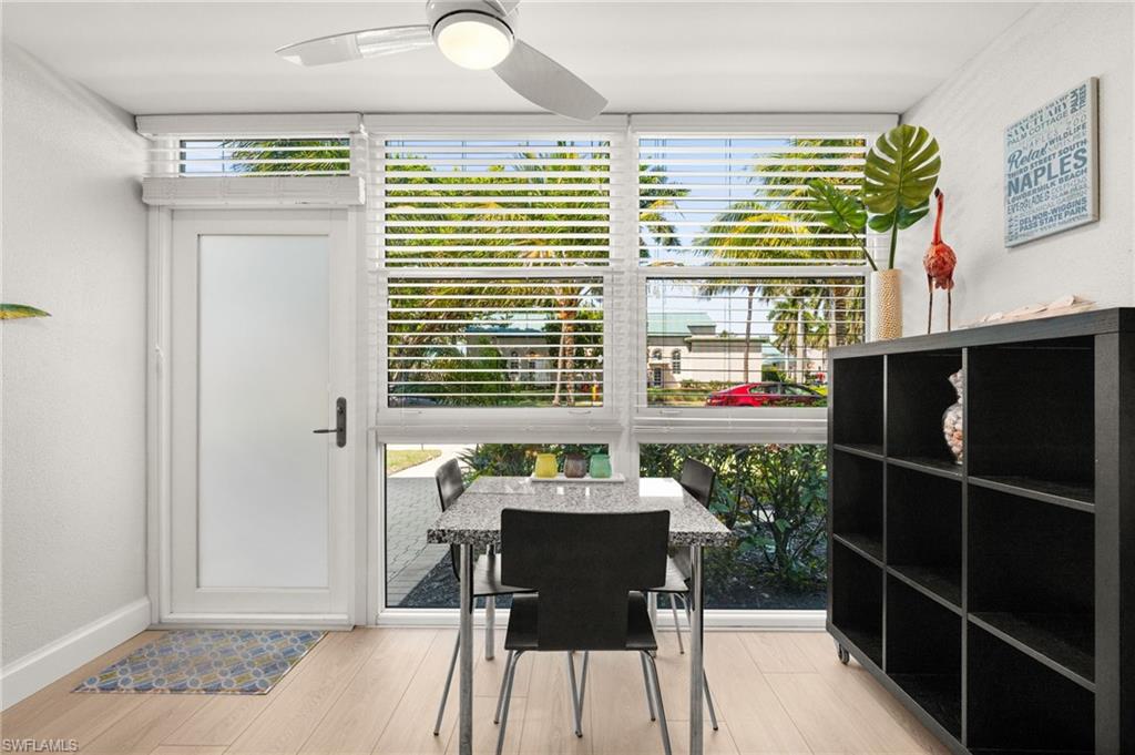 1021 3rd Street South, Unit 108 Naples, FL 34102 - Photo 14 of 31 a view of a dining room with furniture and a window