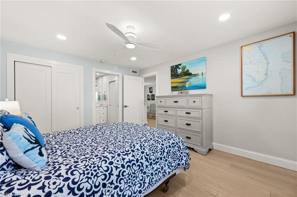 1021 3rd Street South, Unit 108 Naples, FL 34102 - Photo 16 of 31 a bedroom with a bed and a cabinets