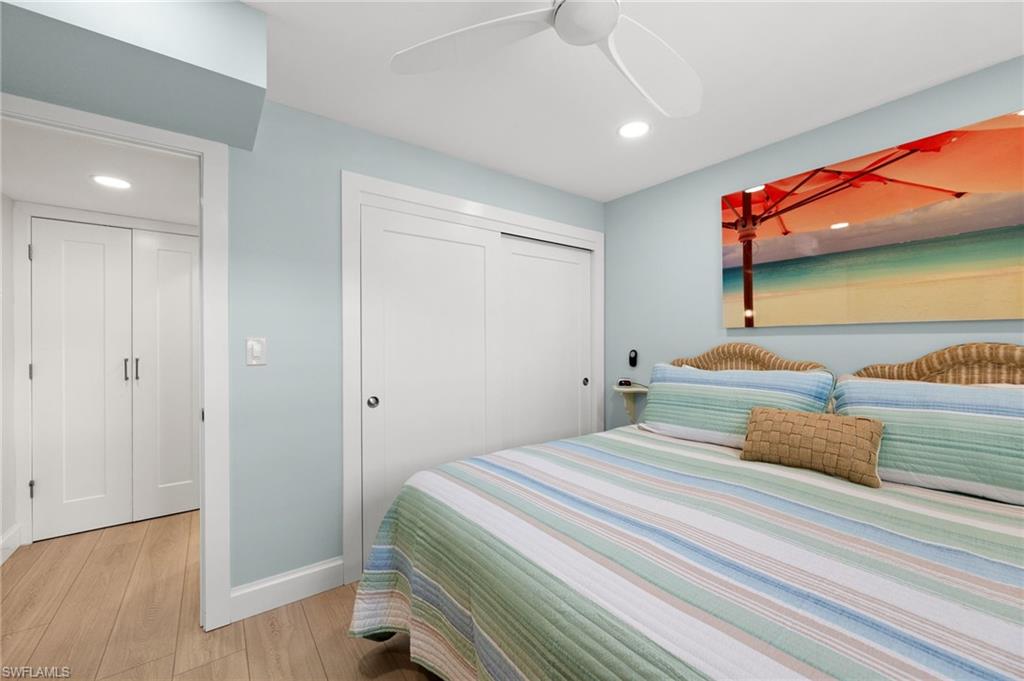 1021 3rd Street South, Unit 108 Naples, FL 34102 - Photo 17 of 31 a bedroom with a bed and a dresser