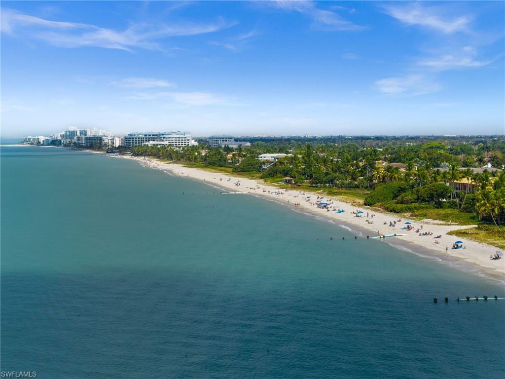 1021 3rd Street South, Unit 108 Naples, FL 34102 - Photo 22 of 31 a view of a lake with houses in the back