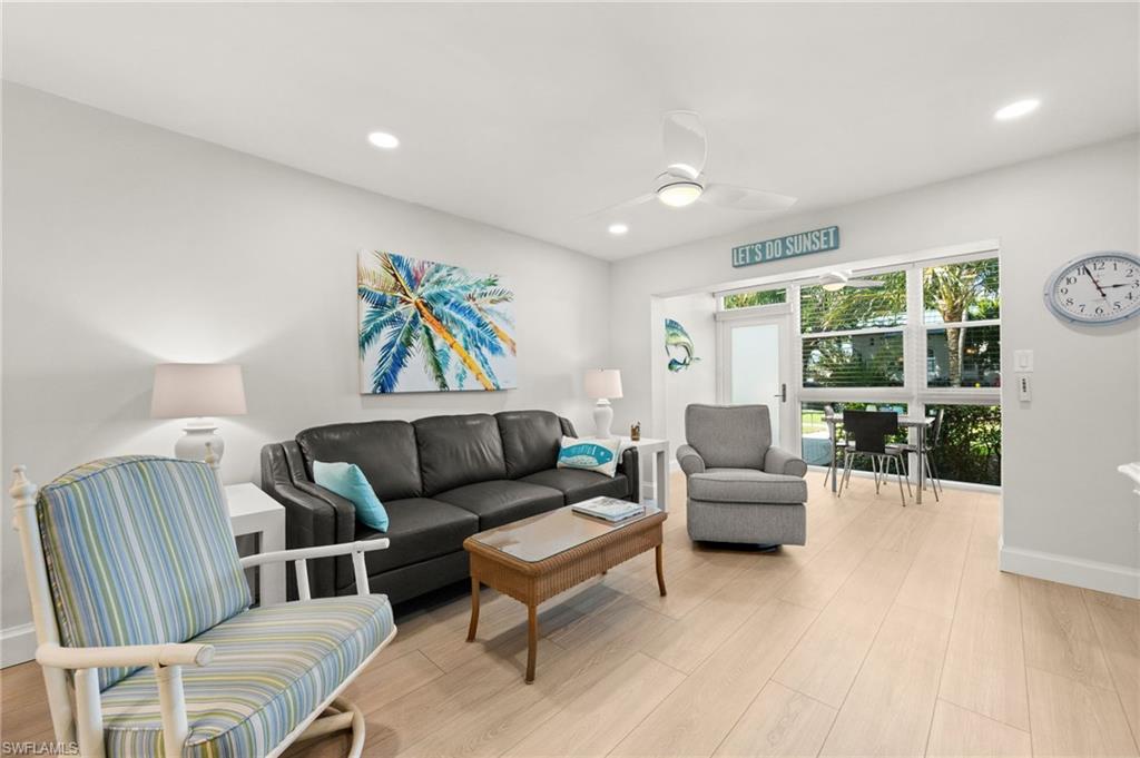 1021 3rd Street South, Unit 108 Naples, FL 34102 - Photo 7 of 31 a living room with furniture and a large window
