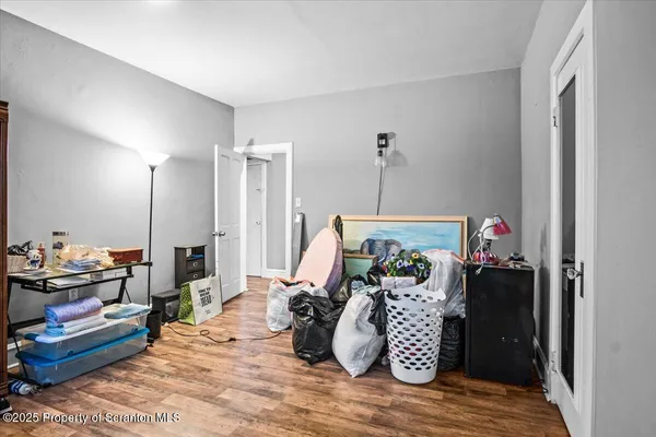 a view of a livingroom with wooden floor and closet