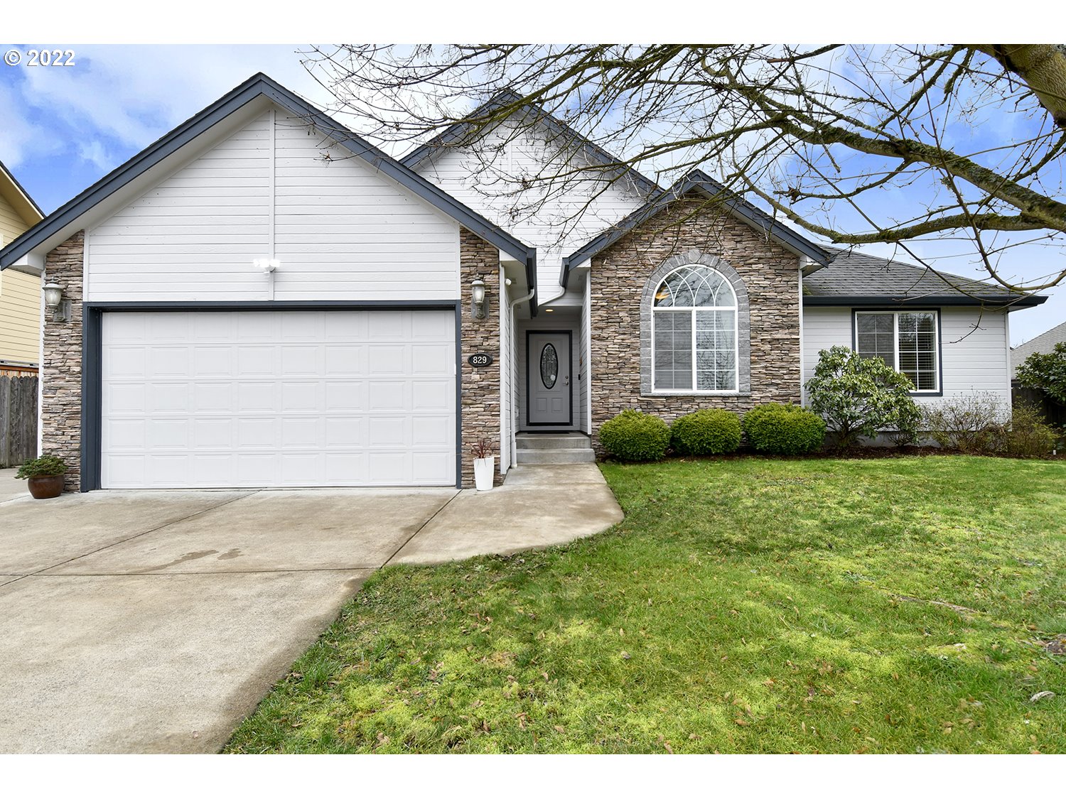 829 T Street Springfield, OR 97477 - Photo 1 of 20 a front view of a house with a yard and garage