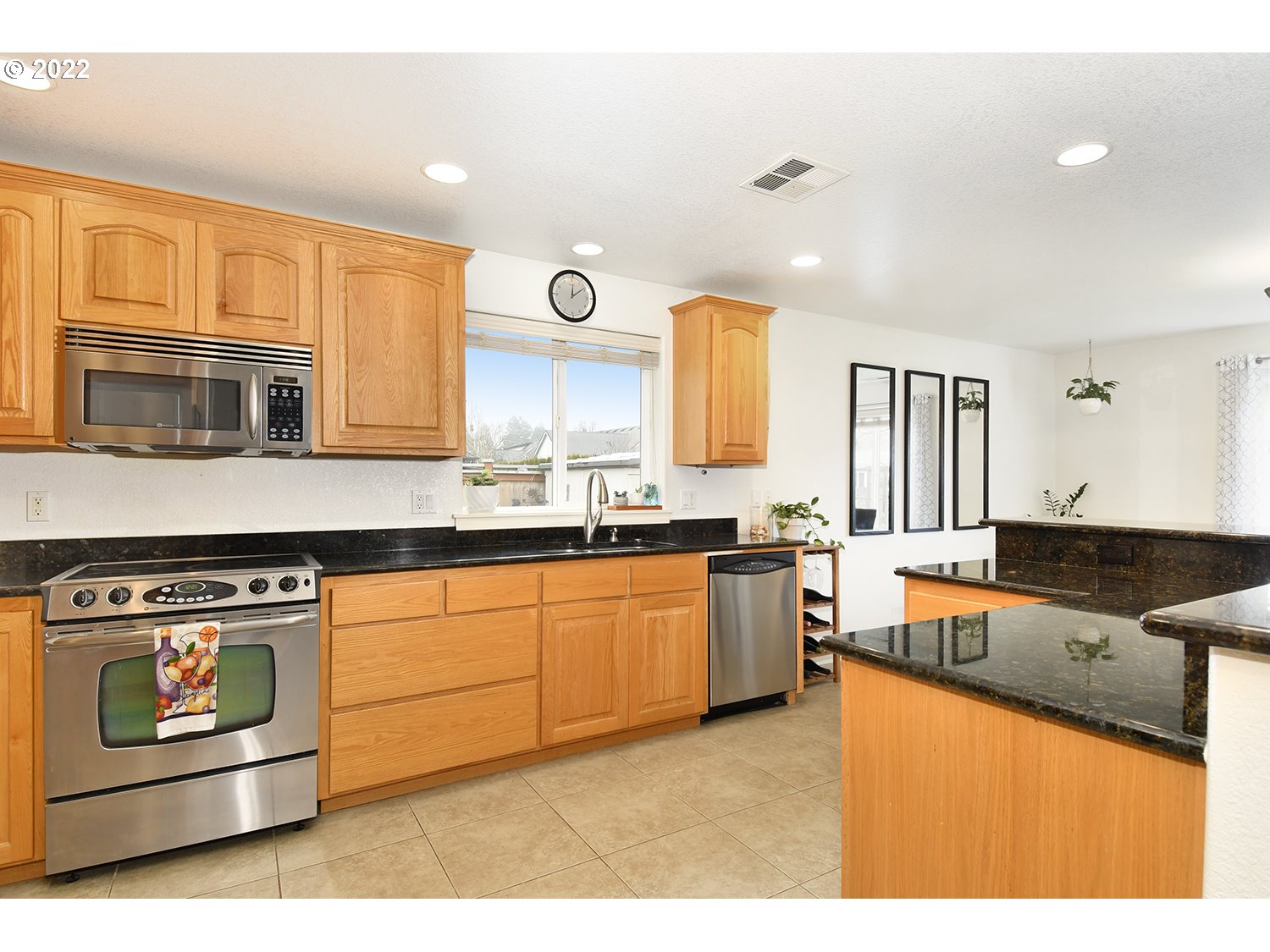 829 T Street Springfield, OR 97477 - Photo 5 of 20 a kitchen with stainless steel appliances granite countertop a stove a sink and a microwave