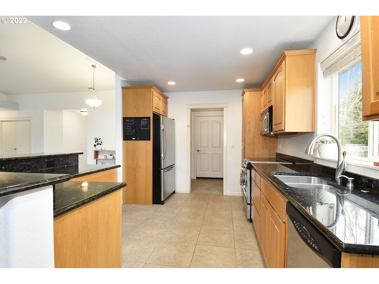 829 T Street Springfield, OR 97477 - Photo 6 of 20 a kitchen with stainless steel appliances granite countertop a sink stove and refrigerator