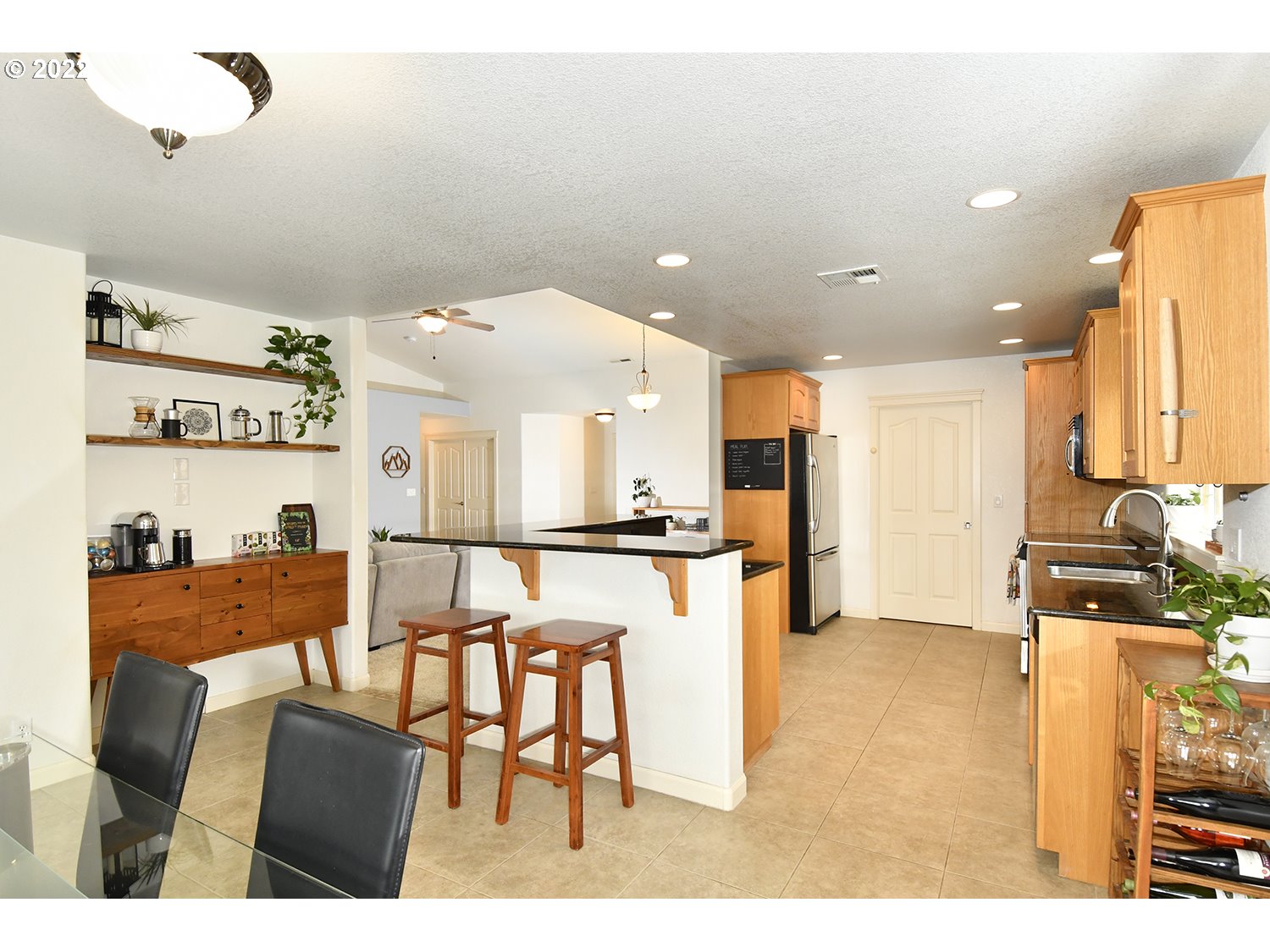 829 T Street Springfield, OR 97477 - Photo 7 of 20 a kitchen with stainless steel appliances kitchen island granite countertop a table and chairs in it