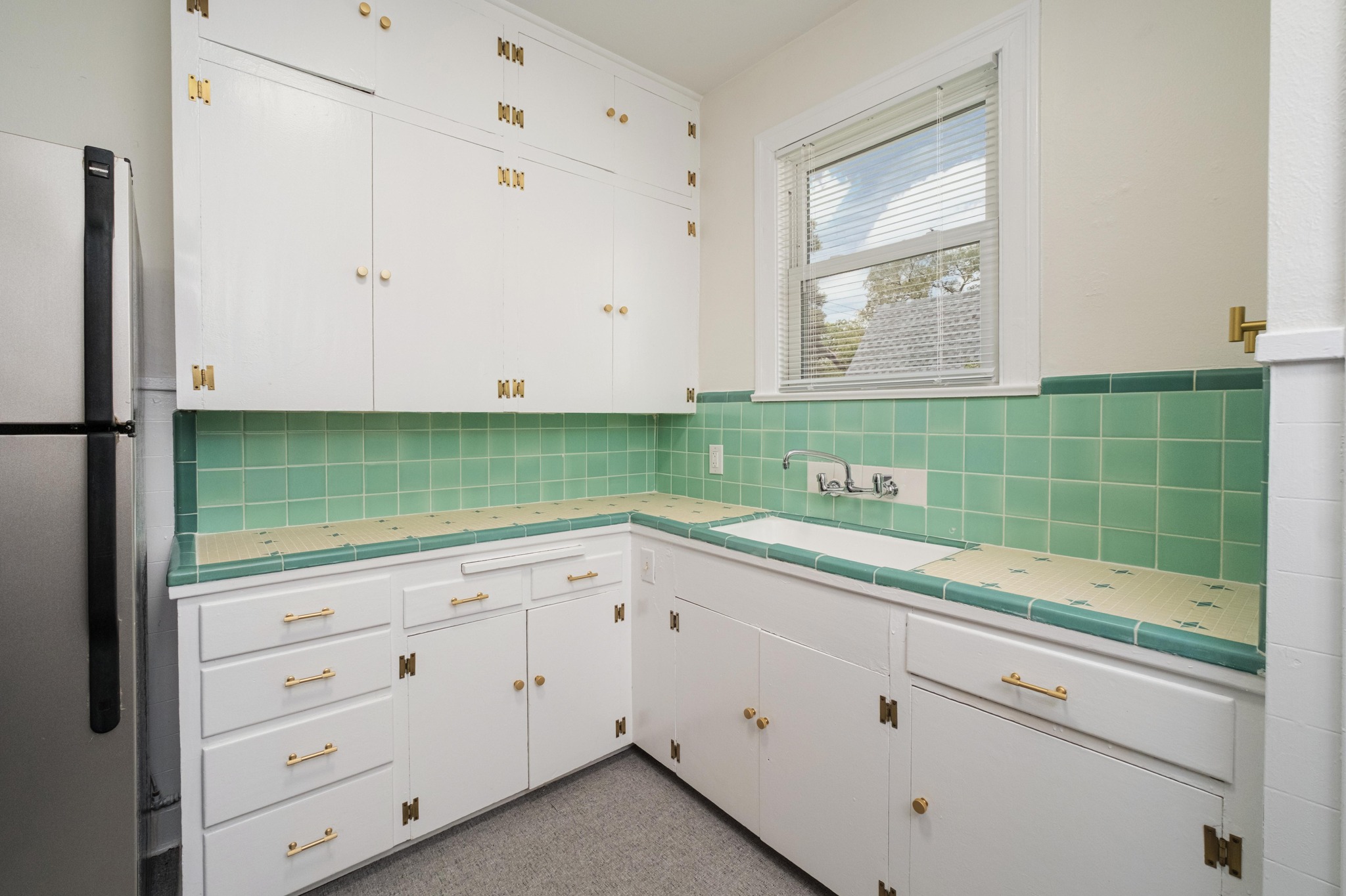 2012 Enfield Road, Unit B Austin, TX 78703 - Photo 6 of 20 A retro-inspired kitchen with classic green tile accents and ample cabinetry.
