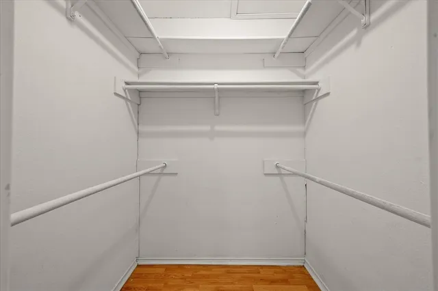 a view of walk in closet with empty racks