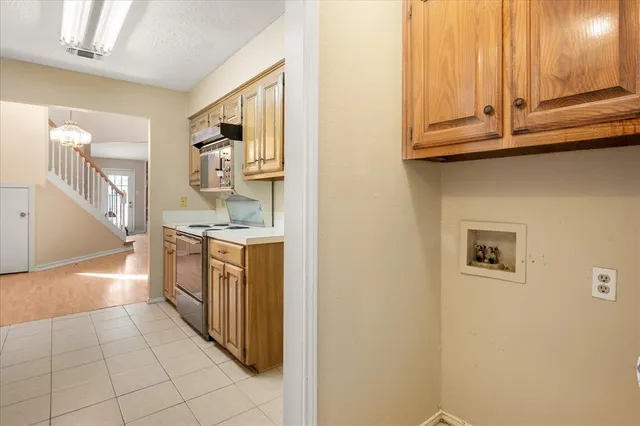 a kitchen with a sink and a stove top oven