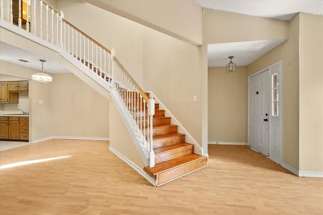 a view of entryway and hall with wooden floor