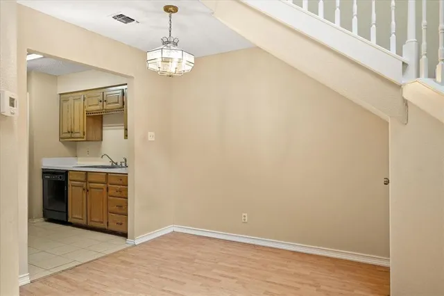 a spacious bathroom with a granite countertop sink a mirror and a vanity
