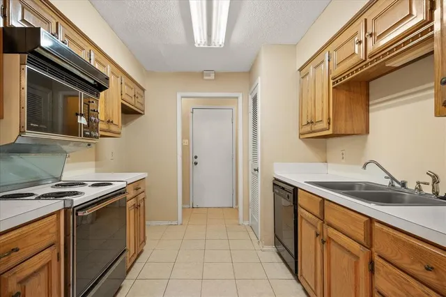 a kitchen that has a sink and a stove