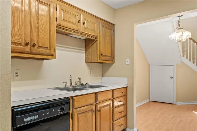 a kitchen with a sink stove and cabinets