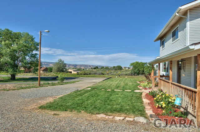 1190-18 18 1/2 Road Fruita, CO 81521 - Photo 3 of 35 a view of a street with houses