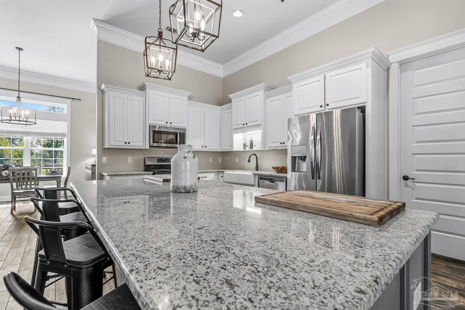 3550 Molino Road Molino, FL 32577 - Photo 21 of 68 a kitchen with stainless steel appliances granite countertop a sink refrigerator stove and microwave