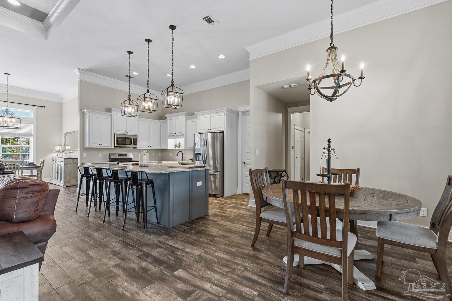 3550 Molino Road Molino, FL 32577 - Photo 23 of 68 a view of a dining room and livingroom with furniture wooden floor a chandelier