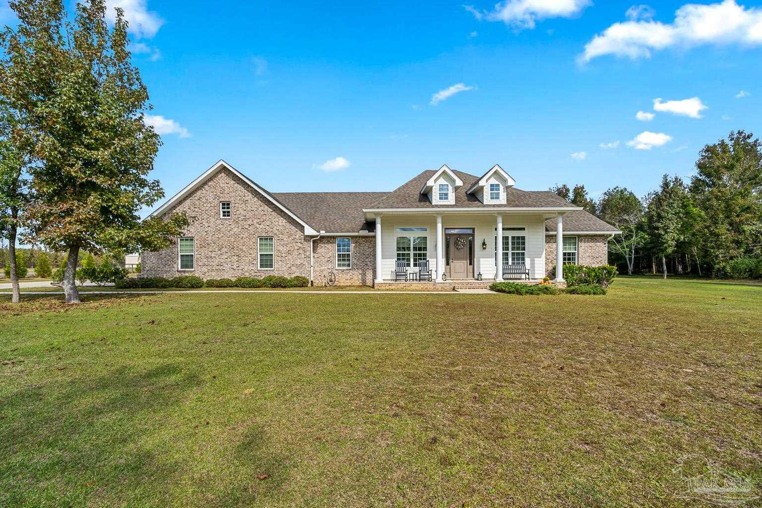 3550 Molino Road Molino, FL 32577 - Photo 4 of 68 a front view of a house with a garden