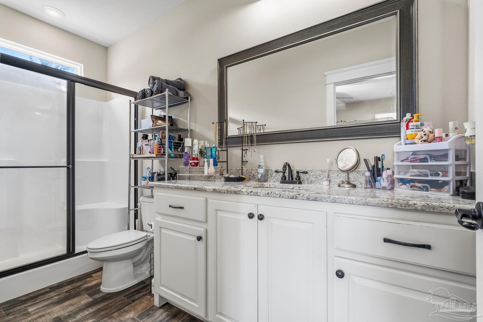 3550 Molino Road Molino, FL 32577 - Photo 44 of 68 a bathroom with a granite countertop sink mirror vanity and toilet