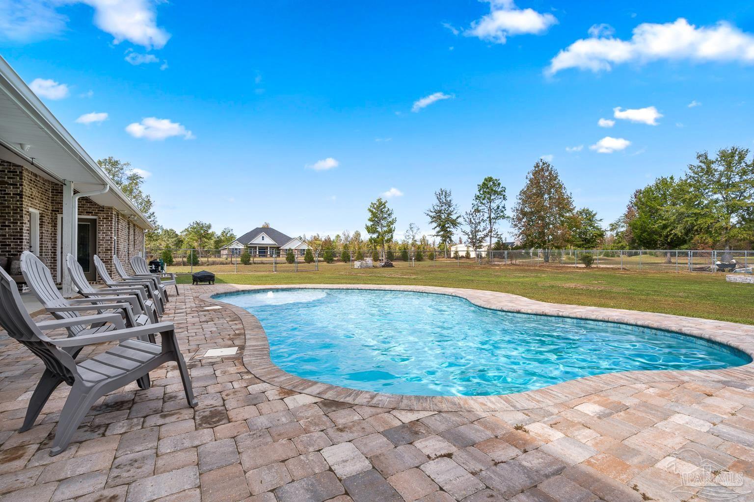 3550 Molino Road Molino, FL 32577 - Photo 51 of 68 a view of a swimming pool and lounge chairs