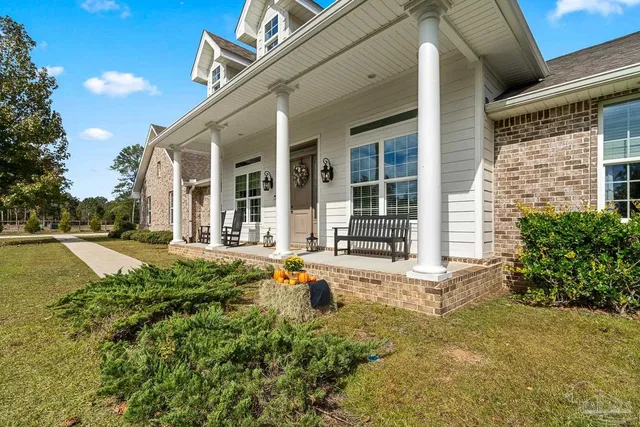 a kitchen with stainless steel appliances granite countertop a stove top oven a sink dishwasher a dining table and chairs with wooden floor