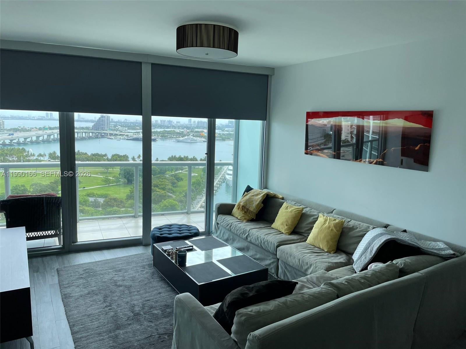 888 Biscayne Boulevard, Unit 1810 Miami, FL 33132 - Photo 15 of 28 a living room with furniture and a floor to ceiling window