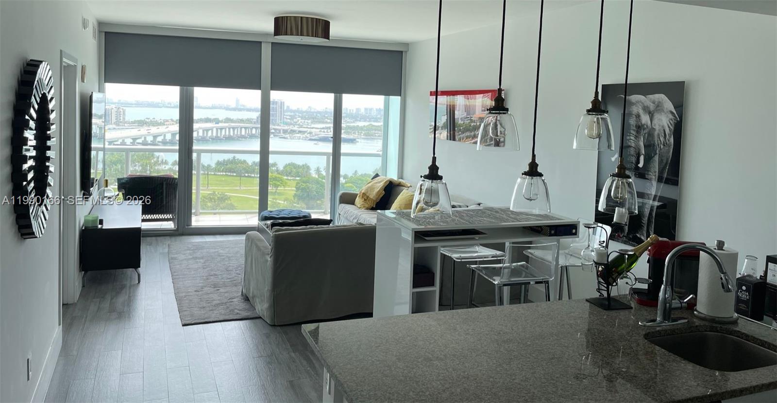888 Biscayne Boulevard, Unit 1810 Miami, FL 33132 - Photo 2 of 28 a living room with furniture and large windows