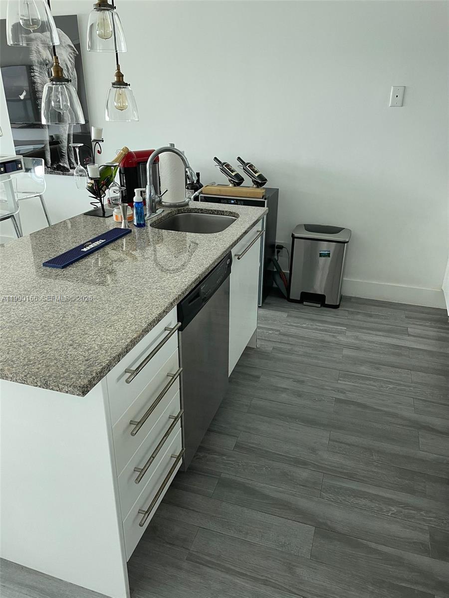 888 Biscayne Boulevard, Unit 1810 Miami, FL 33132 - Photo 21 of 28 a kitchen with sink and cabinets